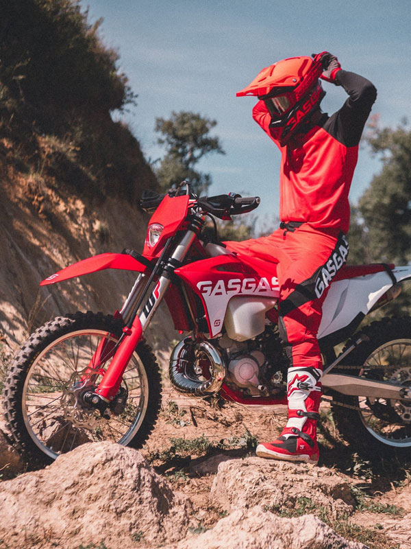 GasGas motorcycle on rocky terrain and rider wearing GasGas clothing